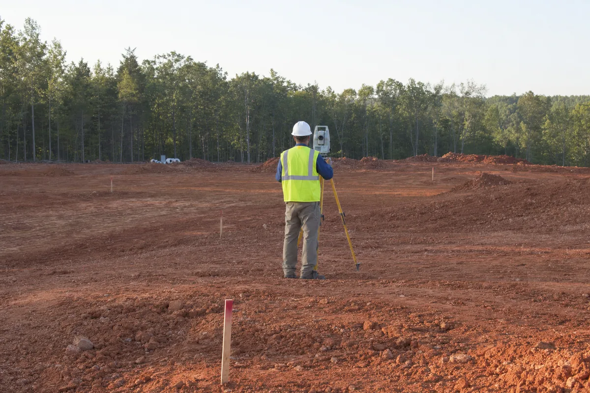 Surveyor working on a graded development site